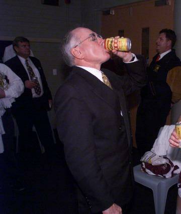 John Howard downing a tinny with Brisbane Broncos player Kevin Walters after their grand final win in 1998. Photo: Andrew Meares