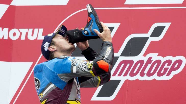 Unusual: MotoGP rider Jack Miller celebrates his victory by drinking from his boot. Photo: Vincent Jannink