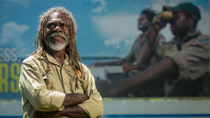 Wardekken ranger and fire management leader Dean Yilbarbuk with the billboard outside Darwin Airport highlighting the importance of the Indigenous Ranger movement.  Photo: Glenn Campbell