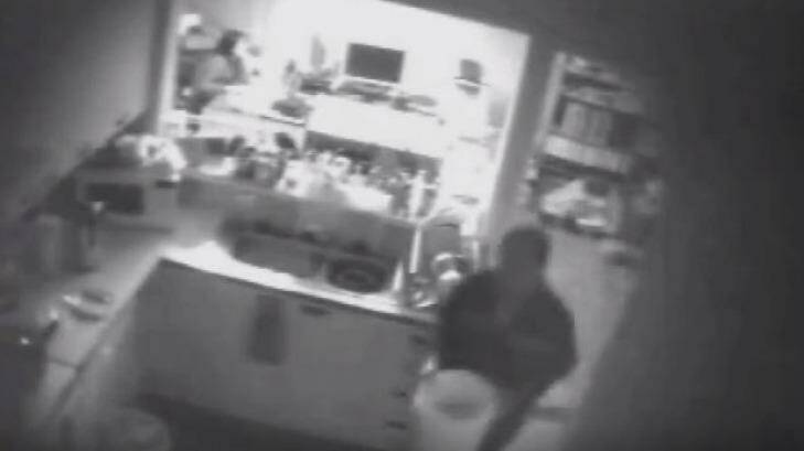Photographic evidence in the Xie trial has finally been released to the media. A still from police surveillance video shows him destroying shoeboxes that could link him to the Lin family murders. Photo: Stephanie Gardiner
