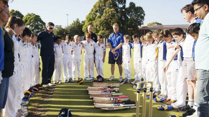 Tribute: Concord Briars Gold and Ryde Hunters Hill Swashbucklers players had a minute of silence for Phillip Hughes before the Under 11s match on Saturday. Photo: James Brickwood