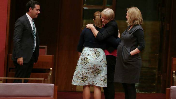 Greens senators Sarah Hanson-Young, Janet Rice and Larissa Waters embrace after the vote. Photo: Alex Ellinghausen