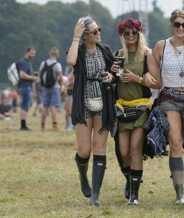 Girls walk across the park with drinks, with left to right, Heather Shillito, Amy Parren, Charlotte Burden and Emma Spafford, enjoying day two of the V Festival, at Weston Park, England, Sunday Aug. 23, 2015.  The annual music festival attracts some top acts. (Joe Giddens / PA via AP) UNITED KINGDOM OUT - NO SALES - NO ARCHIVES Photo: PA