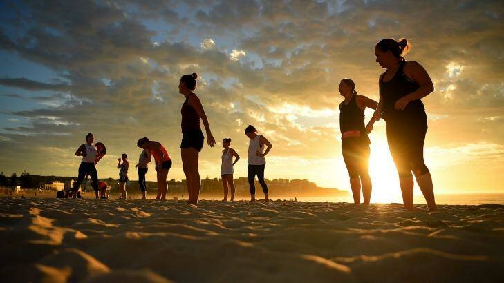 A group of women exercise at Bondi beach before temperatures reached 38 degrees. Photo: Kate Geraghty