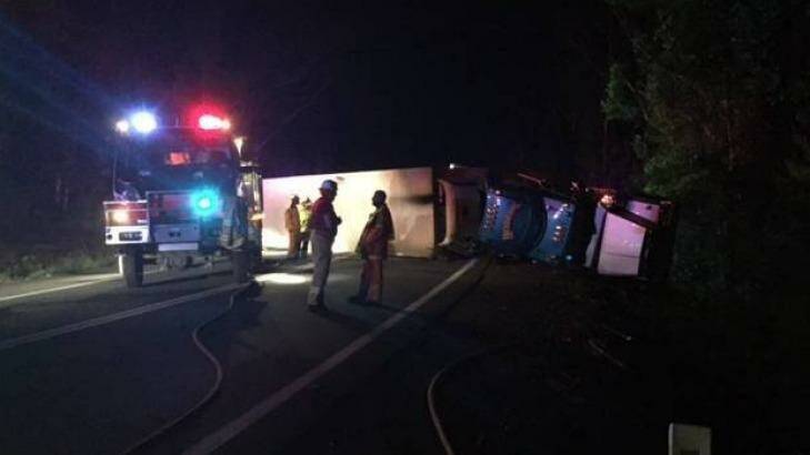 Emergency services had to unload the cheese from the truck to remove it from the highway.  Photo: South Coast Register