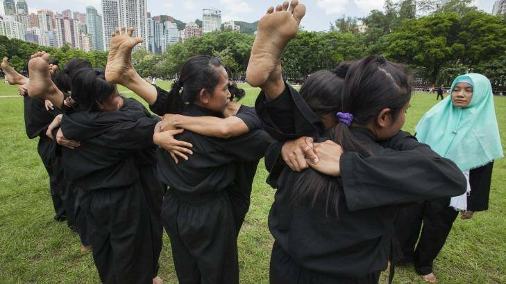 Indonesian domestic helpers practice martial arts training in Victoria Park, Hong Kong, on their day off. Photo: Alex Hofford