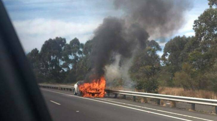 A car fire which sparked a bushfire in Sydney's south on Friday. Photo: Lauren Duck
