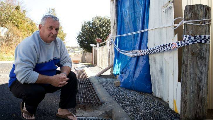 GRIEVING: Garry Burrows, outside his mother's garage where his brother, John, was killed. Photo: WOLTER PEETERS