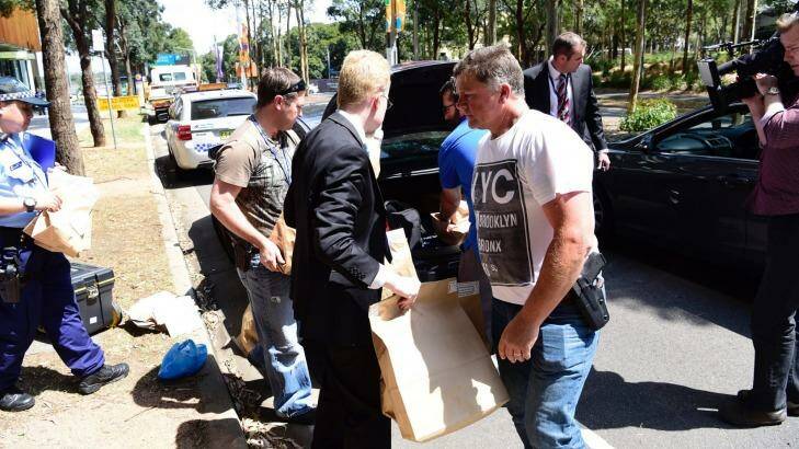 Police take evidence from an upmarket apartment at Sydney's Olympic Park on Tuesday. Photo: Wolter Peeters