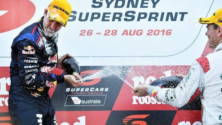 Jamie Whincup, winner of the Sydney SuperSprint, is sprayed by vanquished teammate Craig Lowndes. Photo: Daniel Kalisz
