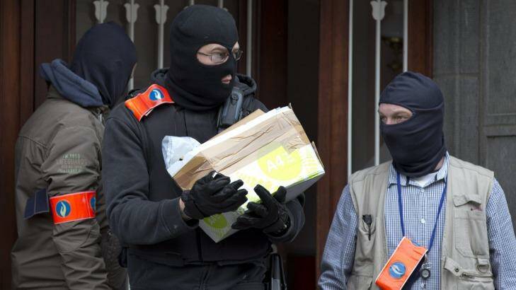 Belgian police leave after an investigation in a house in the Anderlecht neighbourhood in Brussels. Photo: Peter Dejong