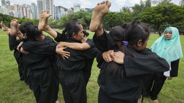 Indonesian domestic helpers practice martial arts training in Victoria Park, Hong Kong, on their day off.  Photo: Alex Hofford