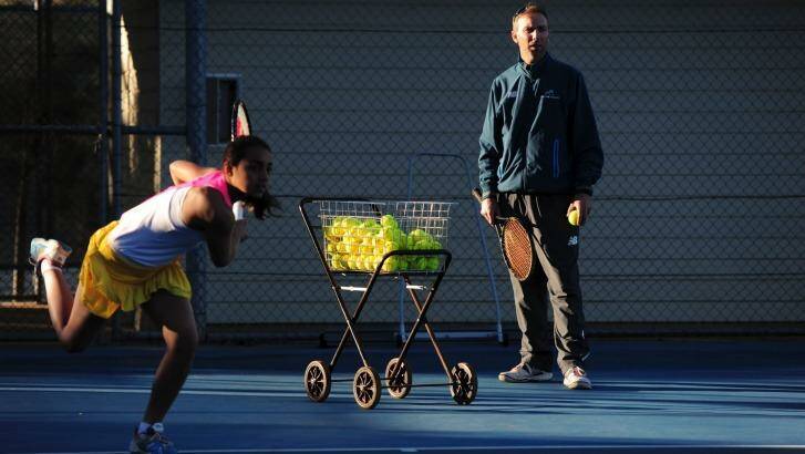 Todd Larkham watches Annerly Poulos train at the AIS courts. Photo: Graham Tidy