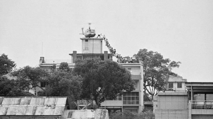 A CIA employee (probably O.B. Harnage) helps Vietnamese evacuees onto an Air America helicopter from from a rooftop near the US Embassy in former Saigon in 1975.

 Photo: Bettmann/Getty Images