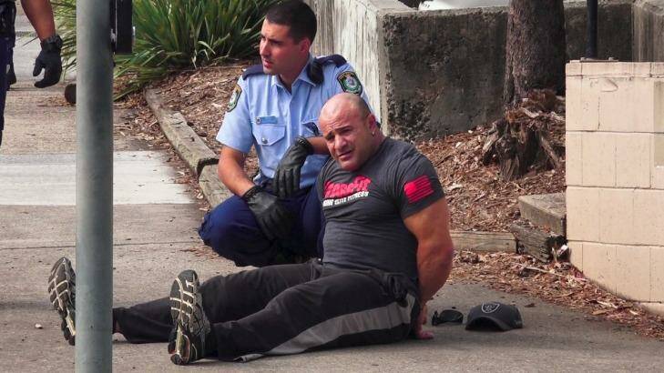 An unidentified man is in custody following the fatal shooting at Bankstown Central Shopping Centre. Photo: Top Notch Video