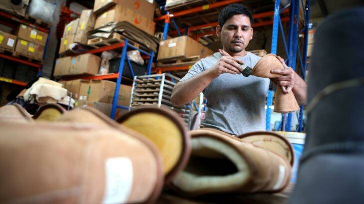 Made in Australia: Zeehan Khan glues together a boot in the Western Sydney factory of Australian Leather. Photo: James Alcock
