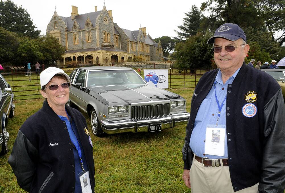 PRIDE AND JOY: Riviera Owners Association national meet organisers Linda and Brian Hall with their 1978 Buick Riviera at Abercrombie House for the Show and Shine yesterday morning. Photo: CHRIS SEABROOK 	052514cbuick1