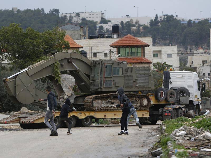 A Palestinian teen who climbed on an Israeli military vehicle has been shot dead.
