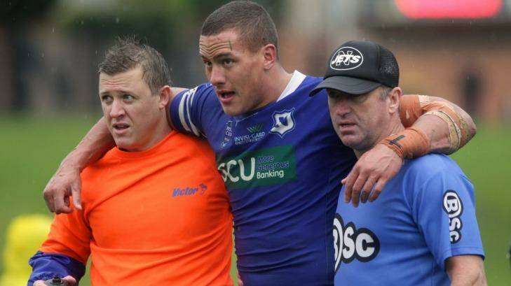 Blessing in disguise: Kane Evans helped off the field after injuring himself in a Newtown Jets game.  Photo: Dallas Kilponen