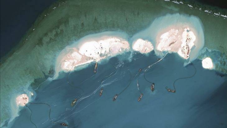 A handout satellite image shows Chinese dredgers working in March at the northernmost reclamation site of Mischief Reef, part of the Spratly Islands, in the South China Sea.  Photo: CSIS