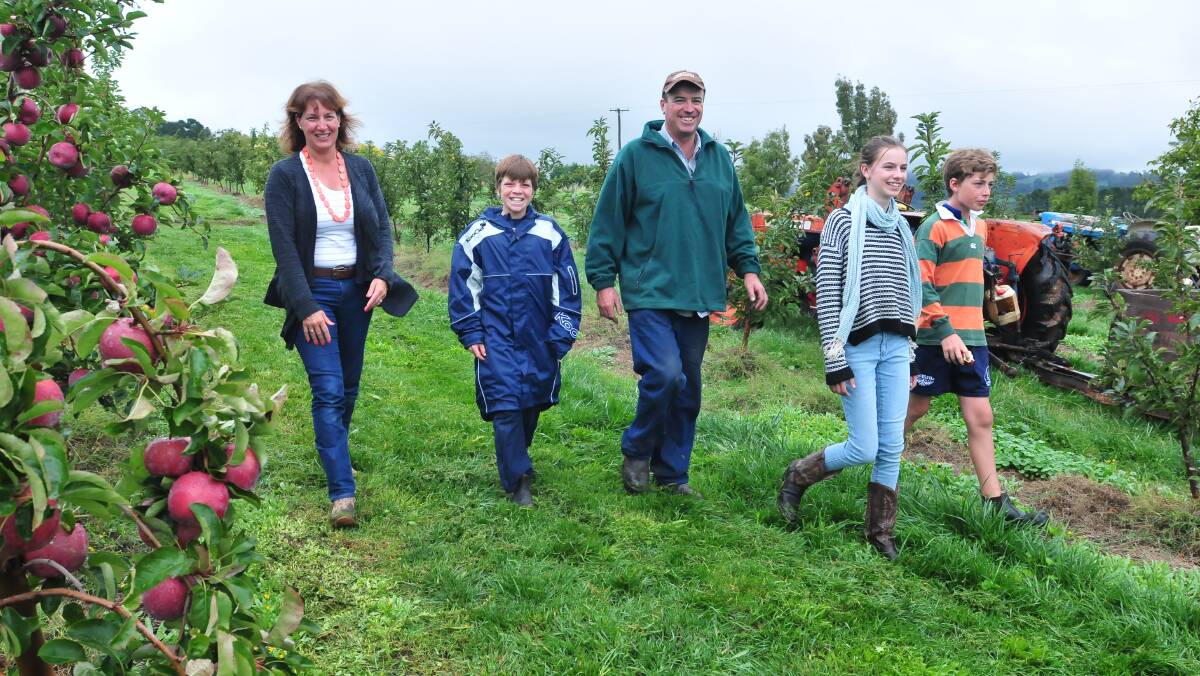 LIVING THE DREAM: Jayne, Harry, Tim, Ellie and Tom West on their orchard. Photo: JUDE KEOGH