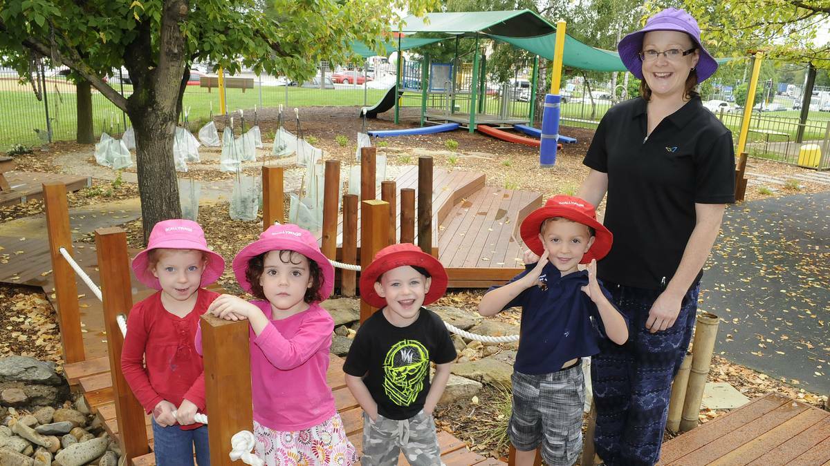 BATHURST: Sophia Tolhurst, Holly Wilkinson, Phoenix Vella and Cooper Healey from Scallywags Child Care Centre headed outdoors with teacher Letitia Ackary to try out the centre’s recently completed natural garden. Photo: CHRIS SEABROOK 032614cgarden