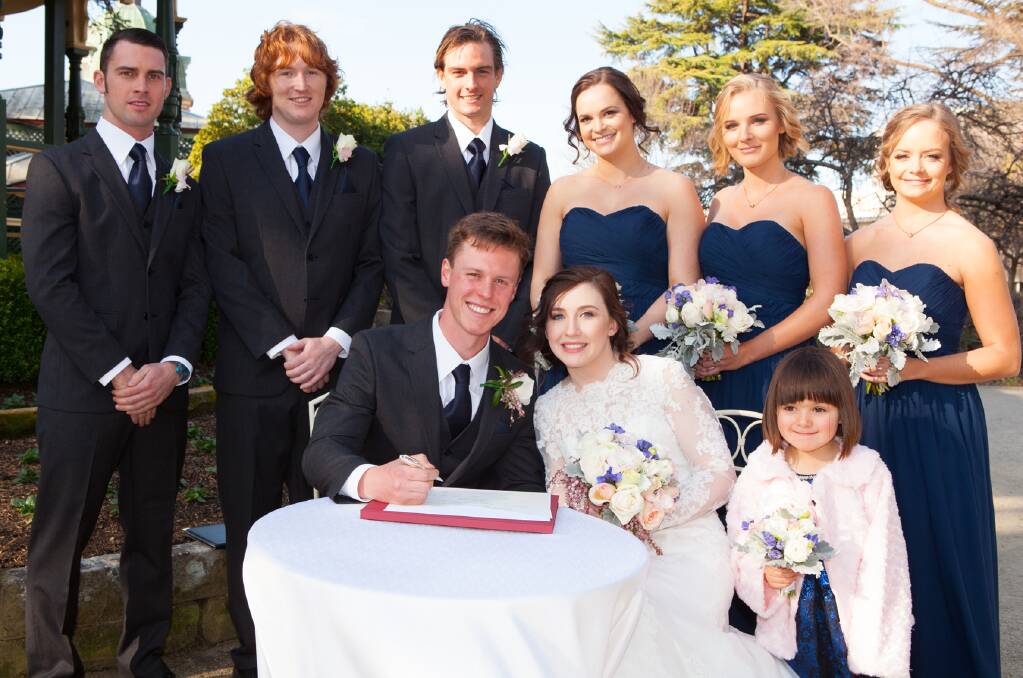 SMITH-BUNYAN WEDDING: Groomsmen Alex Bunyan, Lachlan Campbell and Jeremy Larwance with Bridesmaids Cassandra Moyes, Bonnie Smith and Courtney Ragen. In front is groom Daniel Bunyan, bride Jessica Bunyan and flower girl Anastasia Smith. Photo: CONTRIBUTED
