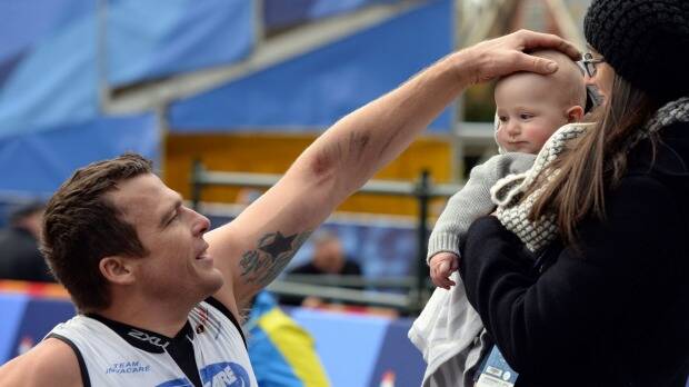 FAMILY WIN: Kurt Fearnley with his wife Sheridan and son Harry after the race. Photo: AFP