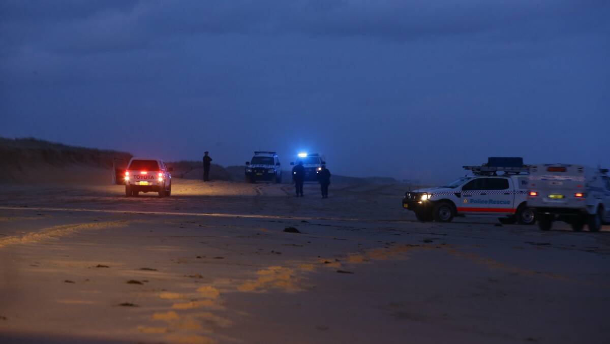 Police at the scene where two bodies washed up on Stockton Bight. Picture: Peter Stoop