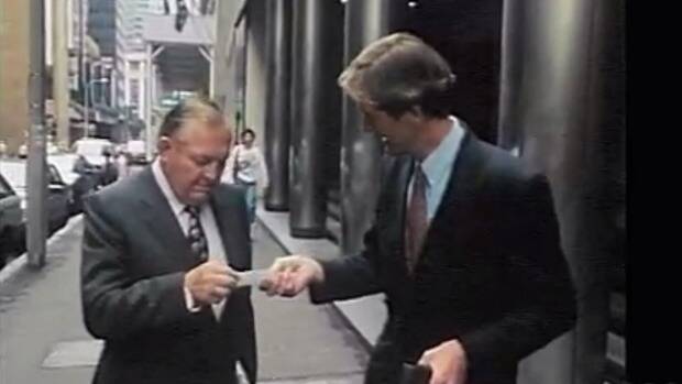 Bond's famous encounter with the current Media Watch host Paul Barry, which lives in media  memory.

Paul Barry hands his business card to Bond, who subsequently threw it on to the ground and stomped on it. Image: Four Corners / ABC.