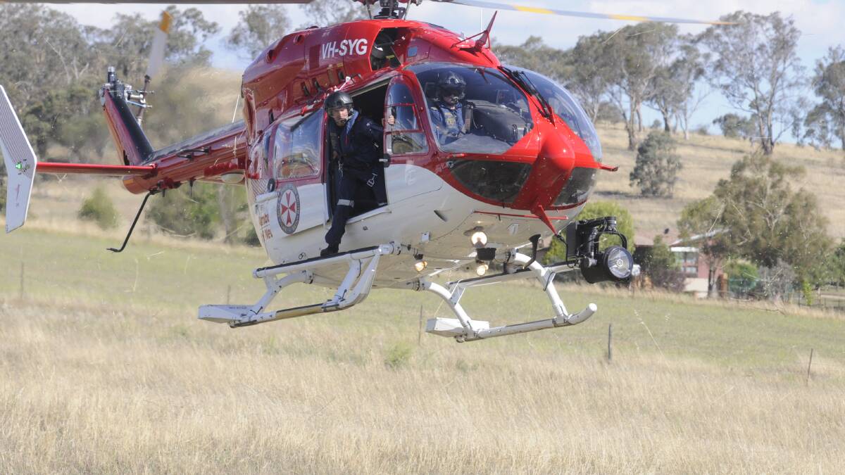 URGENCY: A NSW Air Ambulance helicopter comes into land near the scene of Tuesday’s accident. Photo: CHRIS SEABROOK 120914cmva2a 