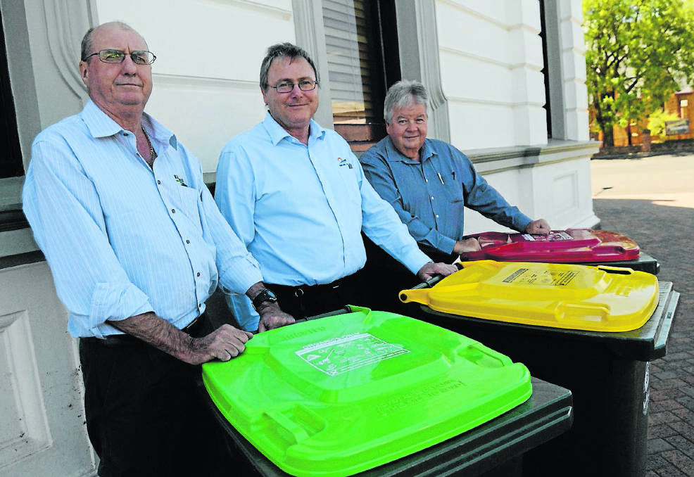Stephen Allcock from JR Richards and Sons, Forbes Shire Council’s Paul Bennett and Greg Turner from JR Richards and Sons, with the new bins that be delivered to Forbes homes next week. 0216bins(6)