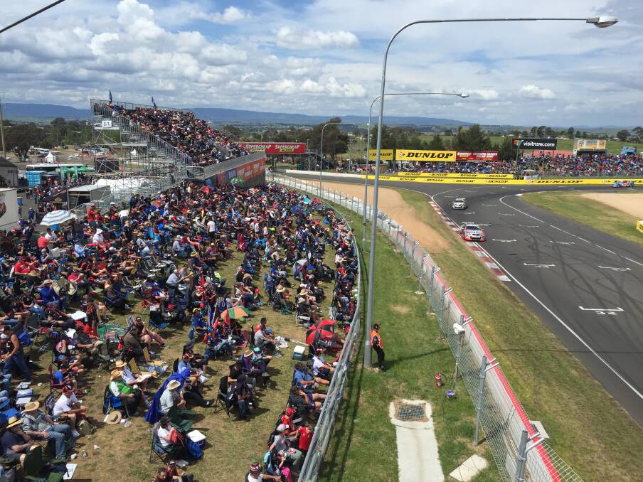 Crowds at Murrays Corner with heavy clouds coming in over the track. Photo: NADINE MORTON