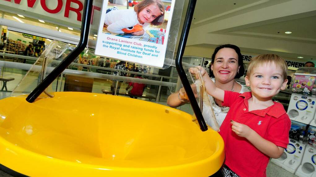 DUBBO: Harry, 2, donates money to a cause that helps his deaf brother, Edward, 7, while mum Susan Chapman looks on. Photo LOUISE DONGES