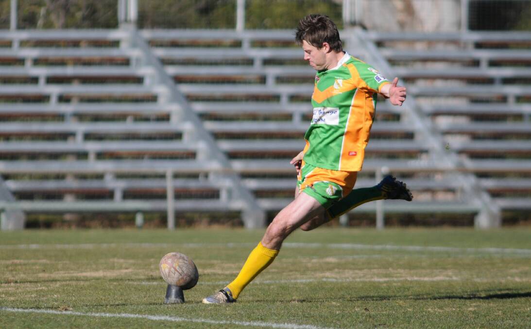 PUTTING IN THE BOOT: Orange CYMS five-eighth Ben McApline, pictured kicking a goal against Oberon last season, will need to fire to ensure the green and golds begin a tough 2015 well. Photo: STEVE GOSCH 0713sgleague15