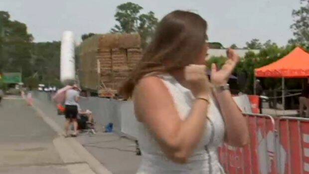Reporter Sarah Hancock turns around as the truck begins to drag the inflatable structure. Photo: ABC News
