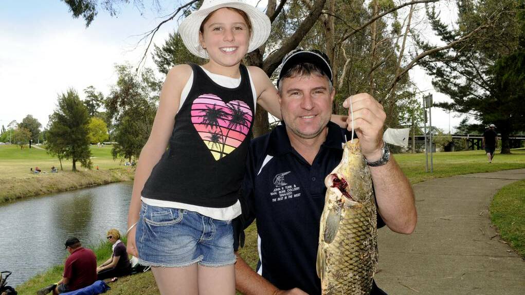 Damien Curran with daughter, Emilee and the 1.88kg carp they caught near Eglinton during the 2014 Carp Blitz. 