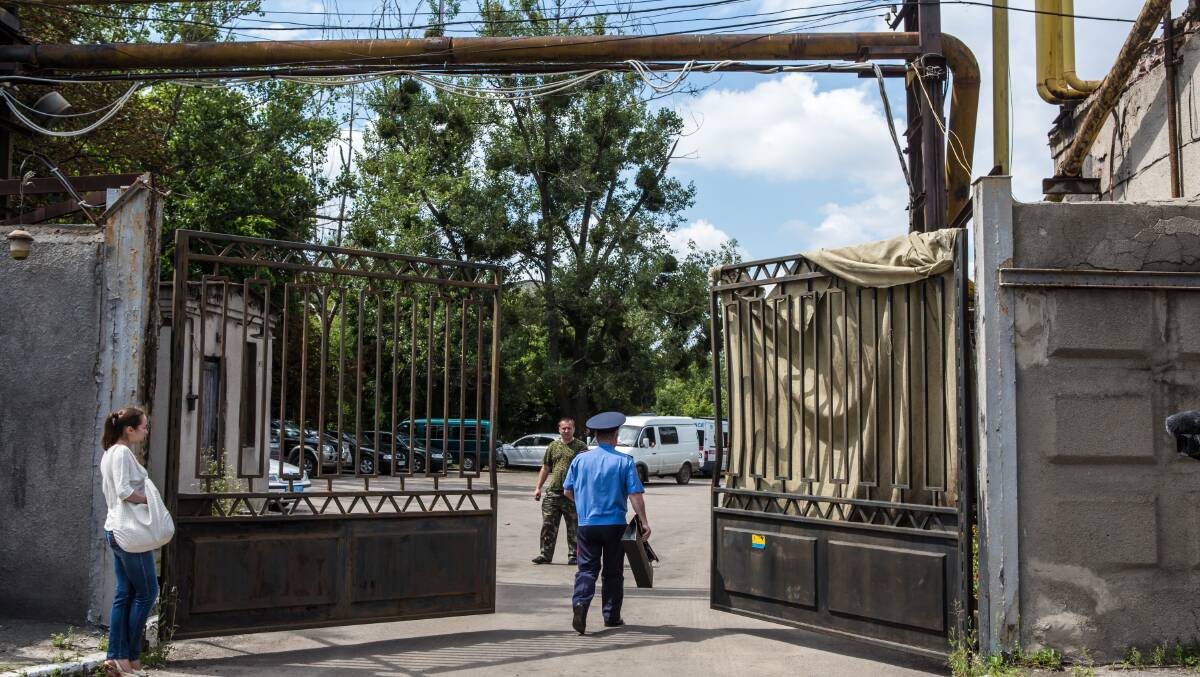 MISSING: The gate of the Malyshev Factory, a state-owned producer of heavy machinery where a train transporting the victims of Malaysia Airlines flight MH17 was taken. Dutch authorities have revealed almost 100 bodies are unaccounted for. Photo: Getty Images/Hagen Hopkins 