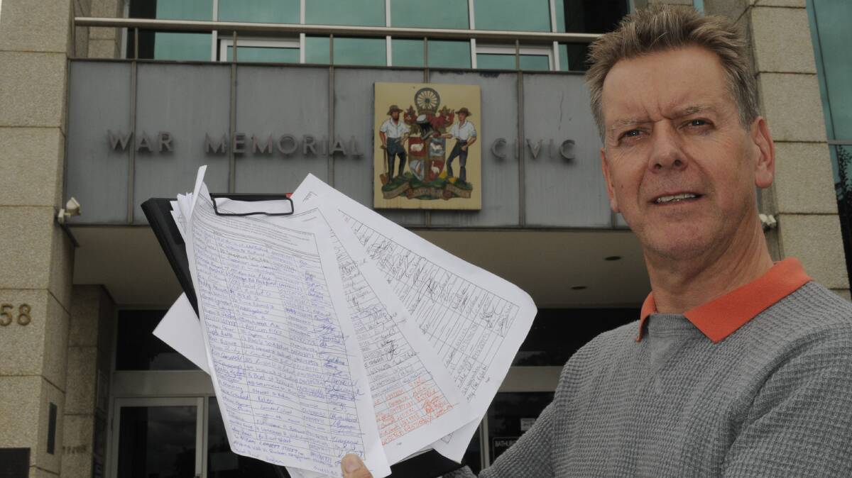 A NUMBER OF NAMES: Brendan McHugh handed a petition to Bathurst Regional Council yesterday after his development application for a new pet boarding kennel at Dunkeld was twice rejected. He says it will help him at his looming court case against the council. Photo: CHRIS SEABROOK 033015cpetitn