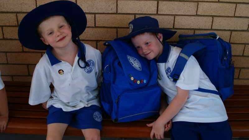 Matthew Capper, kindy, and Timothy Capper, Year 2, after their first day back at St Philomena's, still smiling.  