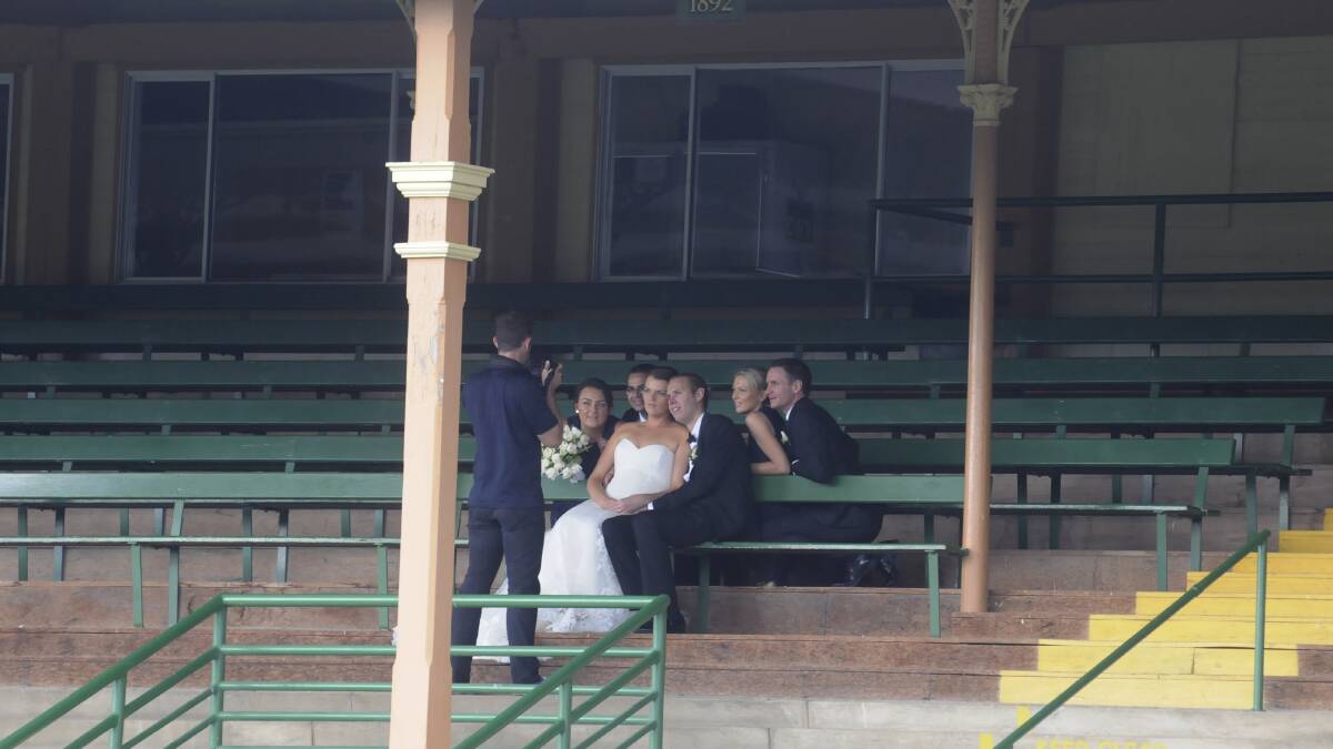 TWO SPECIAL OCCASIONS: While the Bathurst and District Relay for Life was getting underway at the Bathurst Showground, members of this wedding party were spotted having their photos taken in the main grandstand overlooking the relay event. Photo: CHRIS SEABROOK
031514cwedd