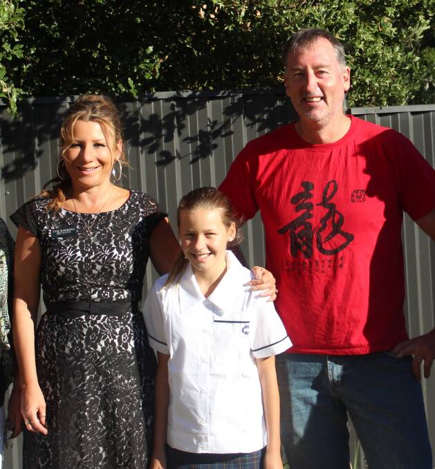  Ivijia De Merli, on her first day in Year 7 at MacKillop College, Bathurst. Photographed with her mum Carissa Campbell, and step-dad Greg Simpson.
 