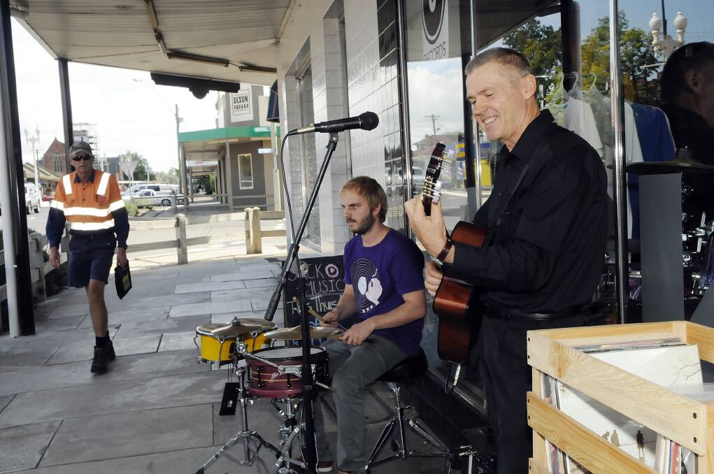 COUNTING THE BEAT: Phil McDowell on drums and Steve Brook on guitar brought live music to Keppel Street during a Sack Music event. Photo: PHILL MURRAY 031314psnap2
