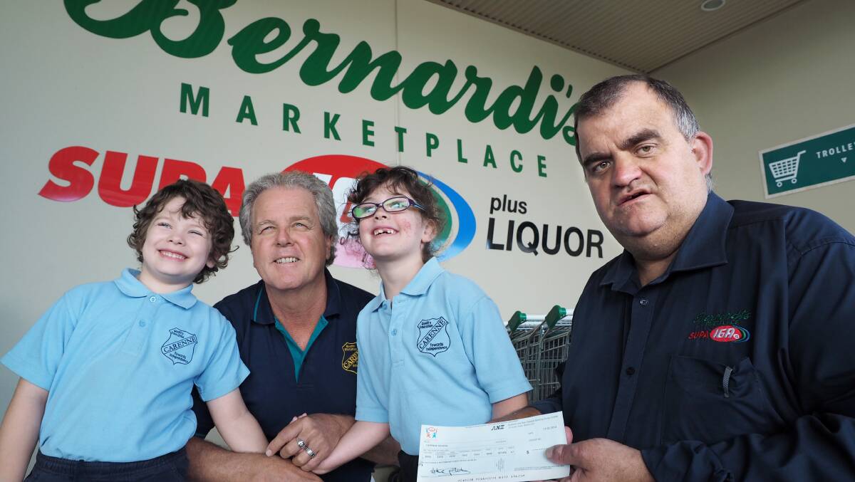GENEROUS: Riley Gooley, Neil Moon and Charlotte McClintock from Carenne Public School receive a cheque from Bernardi’s Marketplace Supa IGA store manager Geoff Bottom for $2297.57 from the Bernardi’s IGA Community Chest. Bernardi’s donated the same amount to Bathurst Daybreak Rotary Club. Photo: ZENIO LAPKA 030614ziga