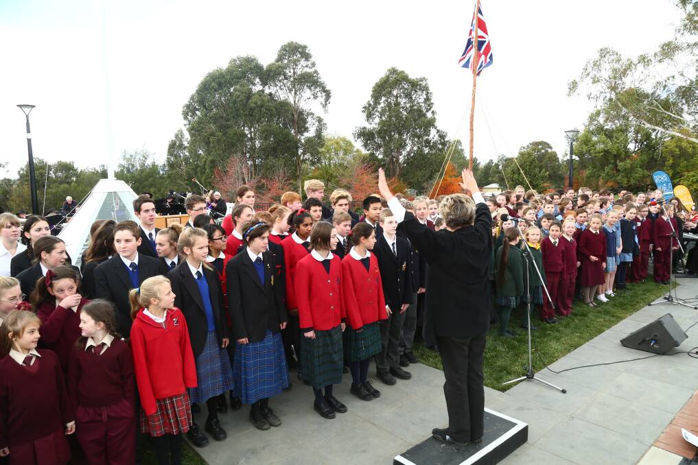 WE ARE ONE: Bathurst’s school children sing We Are Australian as part of the bicentenary celebrations yesterday. Photo: PHIL BLATCH 050715pbflag