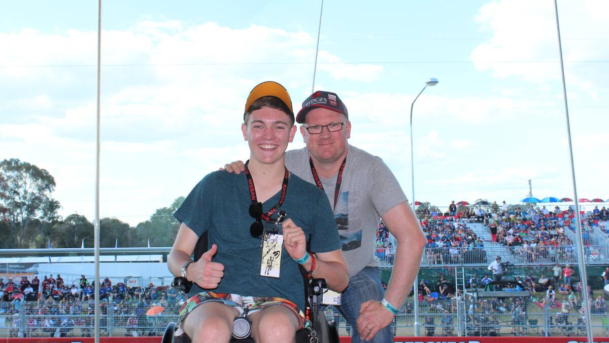 PRIME POSITION: The Starlight Children’s Foundation organised a corporate box for Ben Oakley (left) to allow him to watch his favourite V8 Supercars race trackside. Photo: PHOEBE NEWLING