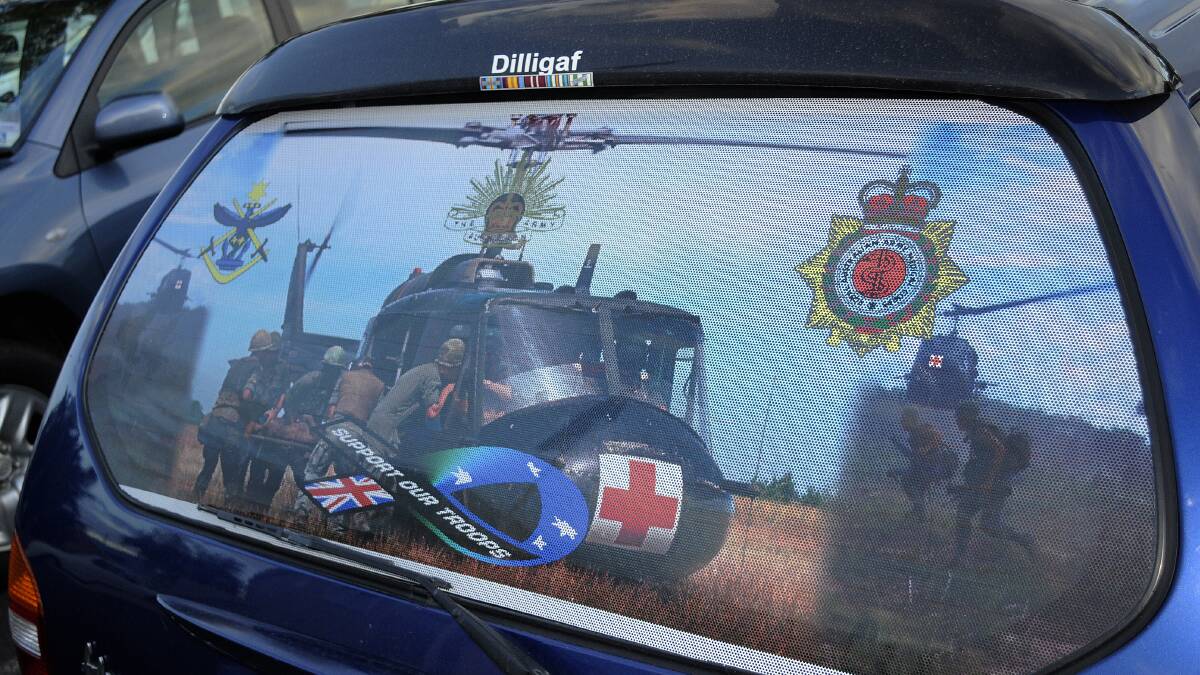 ON THE BIG SCREEN: This vehicle was spotted in the RSL car park. The rear window depicts choppers evacuating wounded soldiers from a battlefield, with the phrase “Support our troops”. Photo: CHRIS SEABROOK 031514crsl7