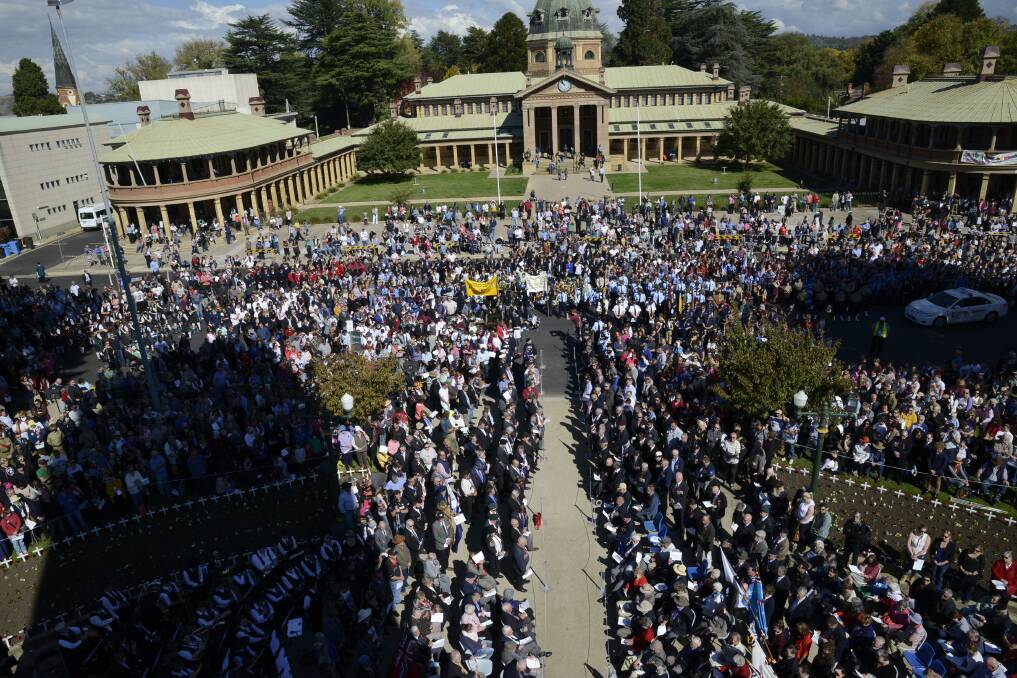 THOUSANDS PAY TRIBUTE: Thousands of people filled Kings Parade and its surrounding streets for the 10:30am Anzac Day service on Saturday. Photo: PHILL MURRAY 042515panzac26
