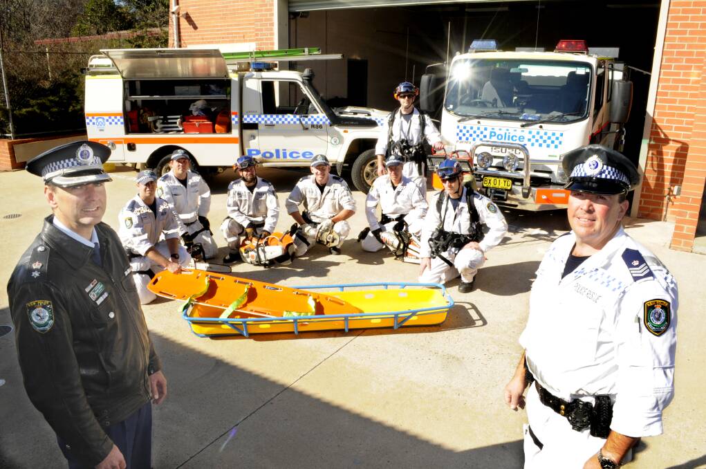 READY TO RESCUE: Superintendent Michael Robinson and Police Rescue co-ordinator Sergeant Lionel White with crew members (at back) Constable Bil Boorer, Constable Matt Holden, Senior Constable Troy Johnson, Senior Constable Nathan Snow-Jones, Constable Phil Richards, Senior Constable Owen Peipman (standing) and Constable Ambrose Volkofsky during yesterday’s training day. Photo: CHRIS SEABROOK 070814cpolresq1