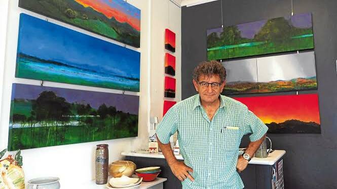 Western Advocate photographer Zenio Lapka has many artistic strings to his bow. He is pictured at the t.arts gallery in Bathurst with his acrylic on canvas paintings ready for tonight's exhibition opening. Photo: LOUISE RANSHAW 040314exhib